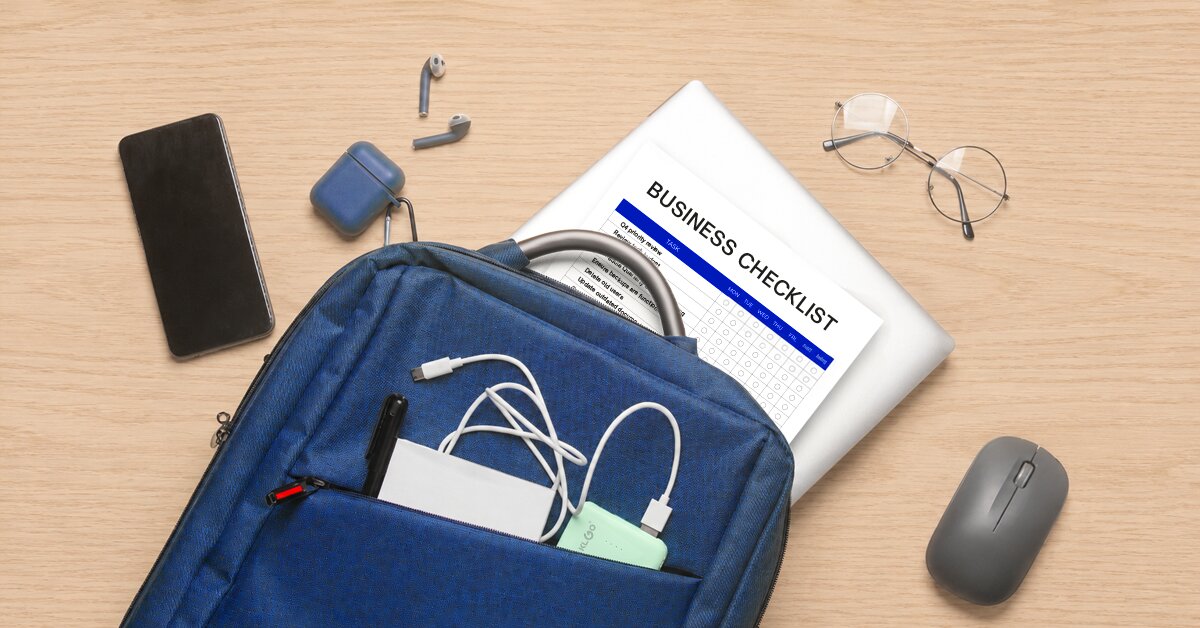 Blue backpack with business checklist and office supplies on desk
